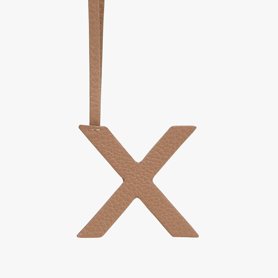 Letter X hanging from a string