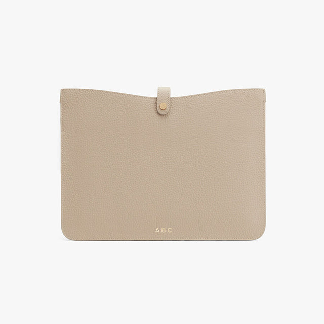 Envelope clutch with front flap closure and initials 'ABC'.