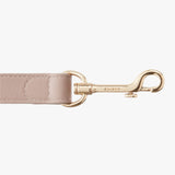 Leather strap with metal clasp and engraved brand name.