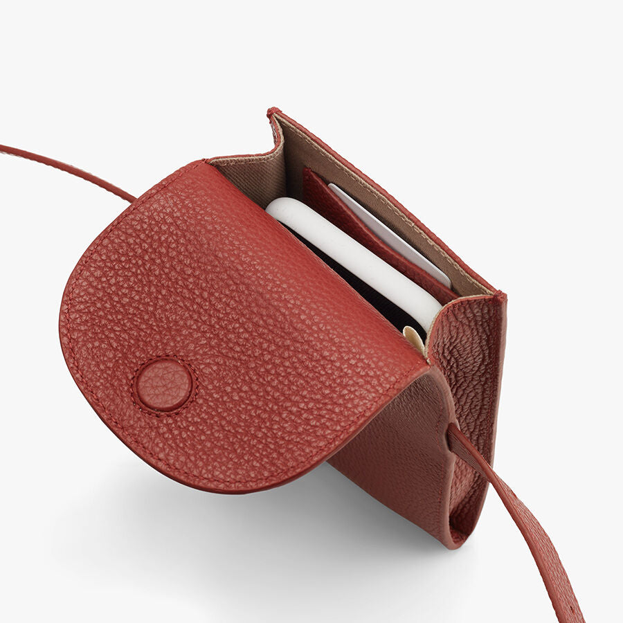 Convertible Belt Bag Small open purse with visible contents including a smartphone.