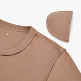 Close-up of a shirt with a snap-button collar and detached detail.