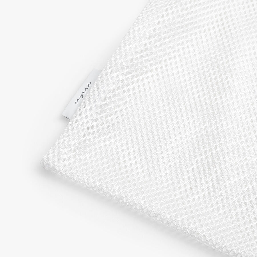 Close-up of a textured fabric with a small tag