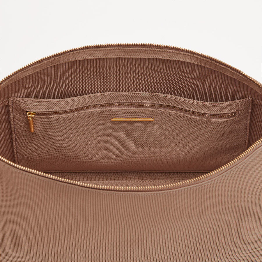 Open bag with visible inner zipper pocket.