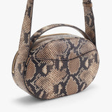 Patterned round shoulder bag with zipper closure.