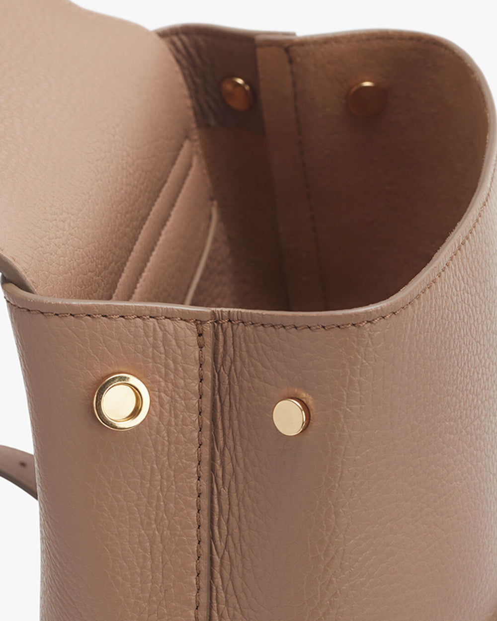 Close-up view of a bag with metallic rivets.