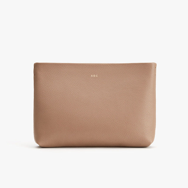 Leather pouch with initials ABC on front against a plain background.
