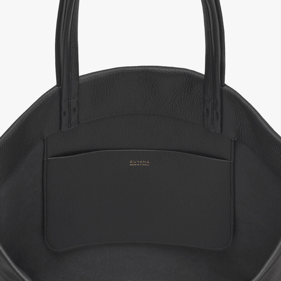 Top view of a handbag with two handles and a front pocket.