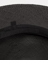 Close-up view of a textured hat with a ribbon band.