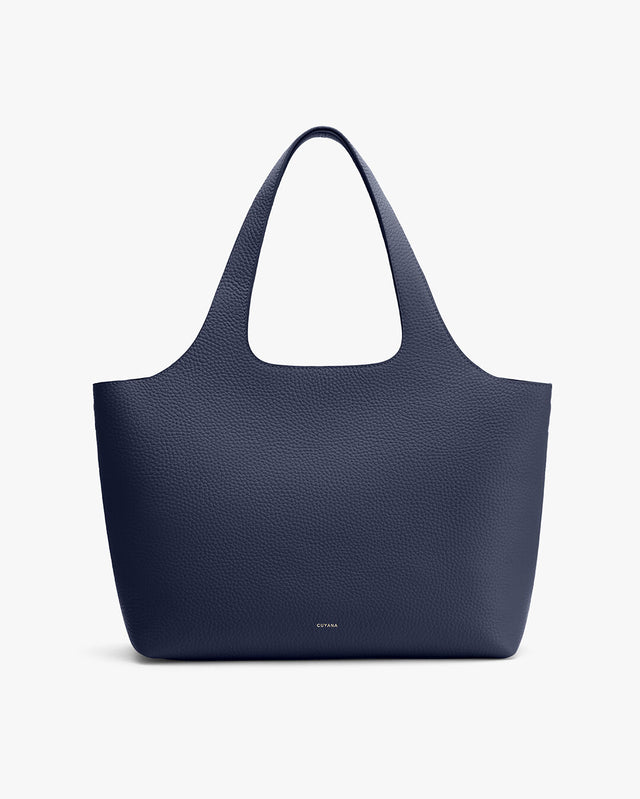 A large tote bag with two handles and a textured surface.
