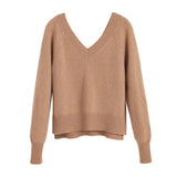 Sweater with long sleeves and a V-neckline on a plain background.