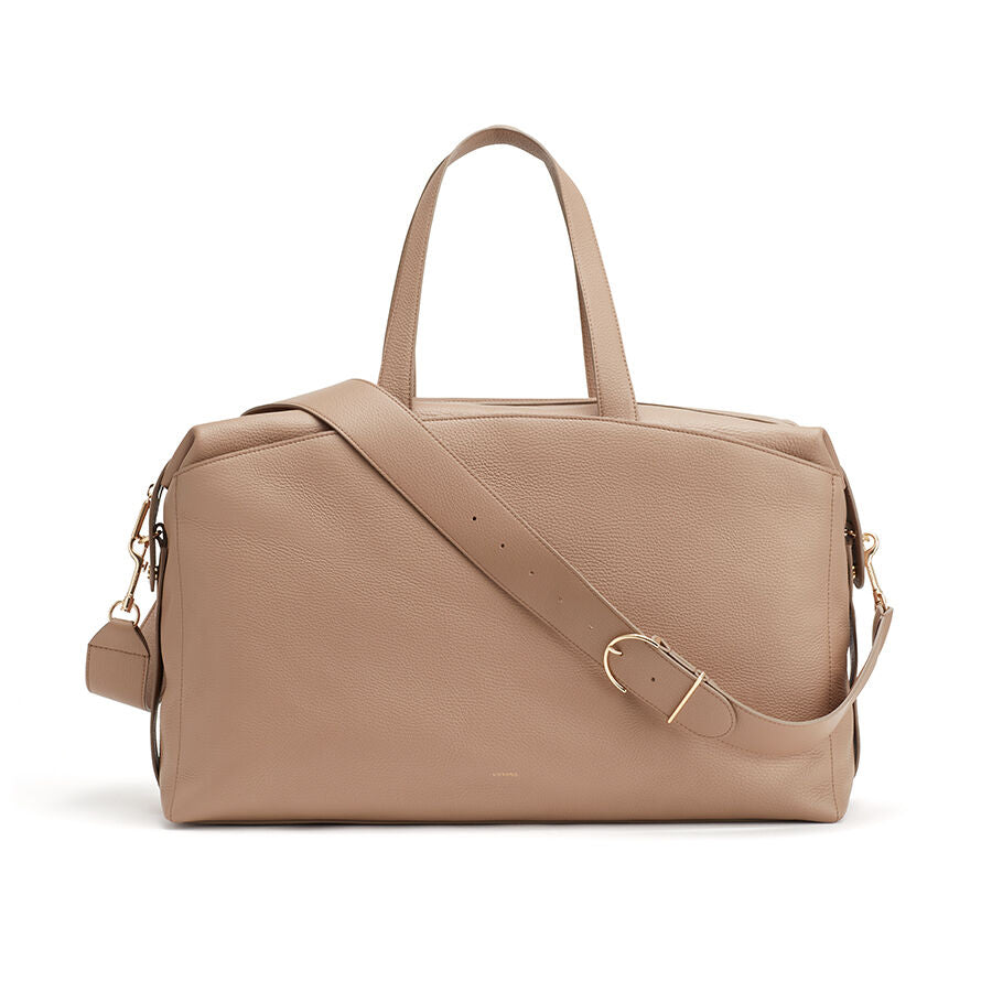 Handbag with handles and a shoulder strap, isolated on a white background.