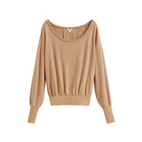Long-sleeve scoop neck top with elastic waistband, displayed on plain background.