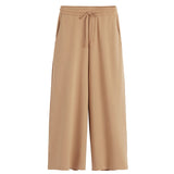 A pair of wide-legged pants with a drawstring waist.
