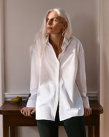 Woman standing by a table looking to the side