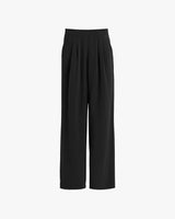 High-waisted pleated trousers on a white background.