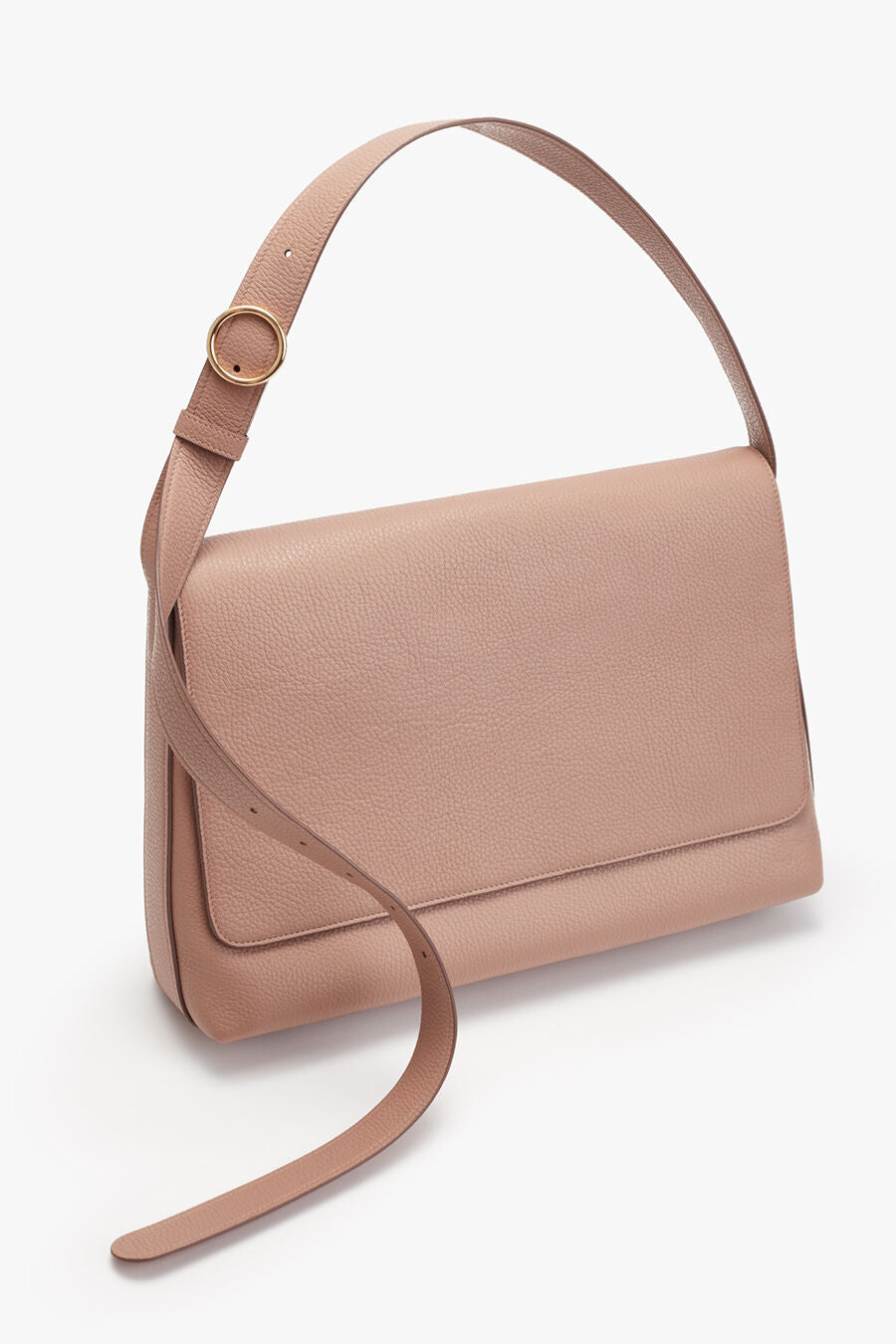 Handbag with adjustable strap and flap closure leaning against a plain background.