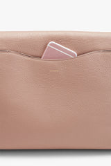 Smartphone peeking out of a handbag's pocket.