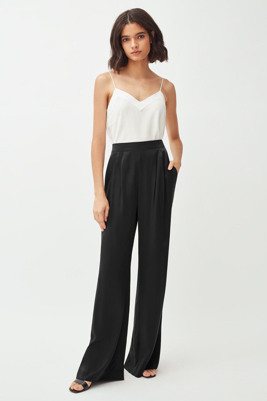 Washable Charmeuse Wide-Leg Pant Woman standing in a sleeveless top and wide-legged pants.