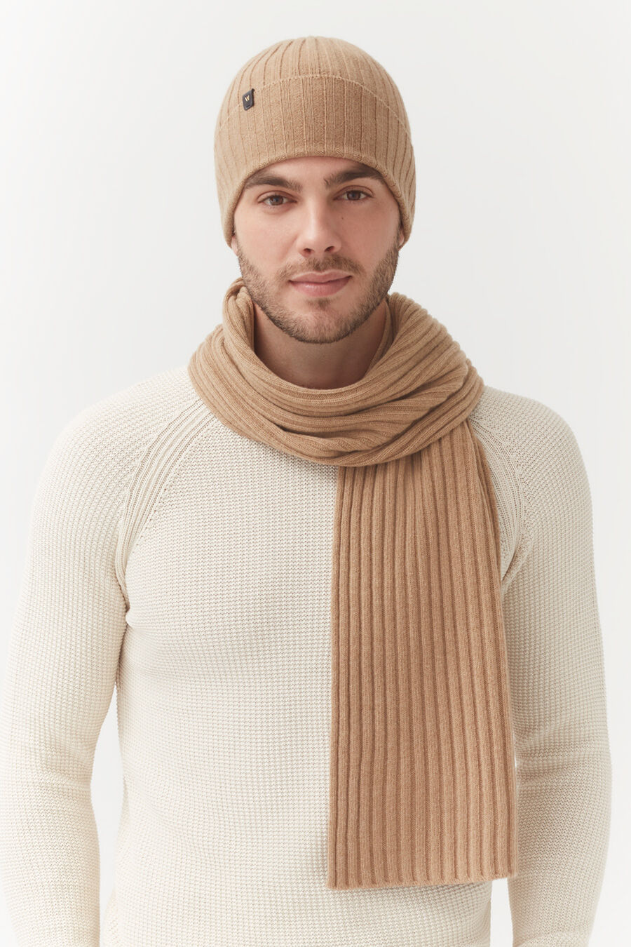 Mens Wool Cashmere Ribbed Scarf Man wearing a beanie and scarf with a sweater, looking at the camera.