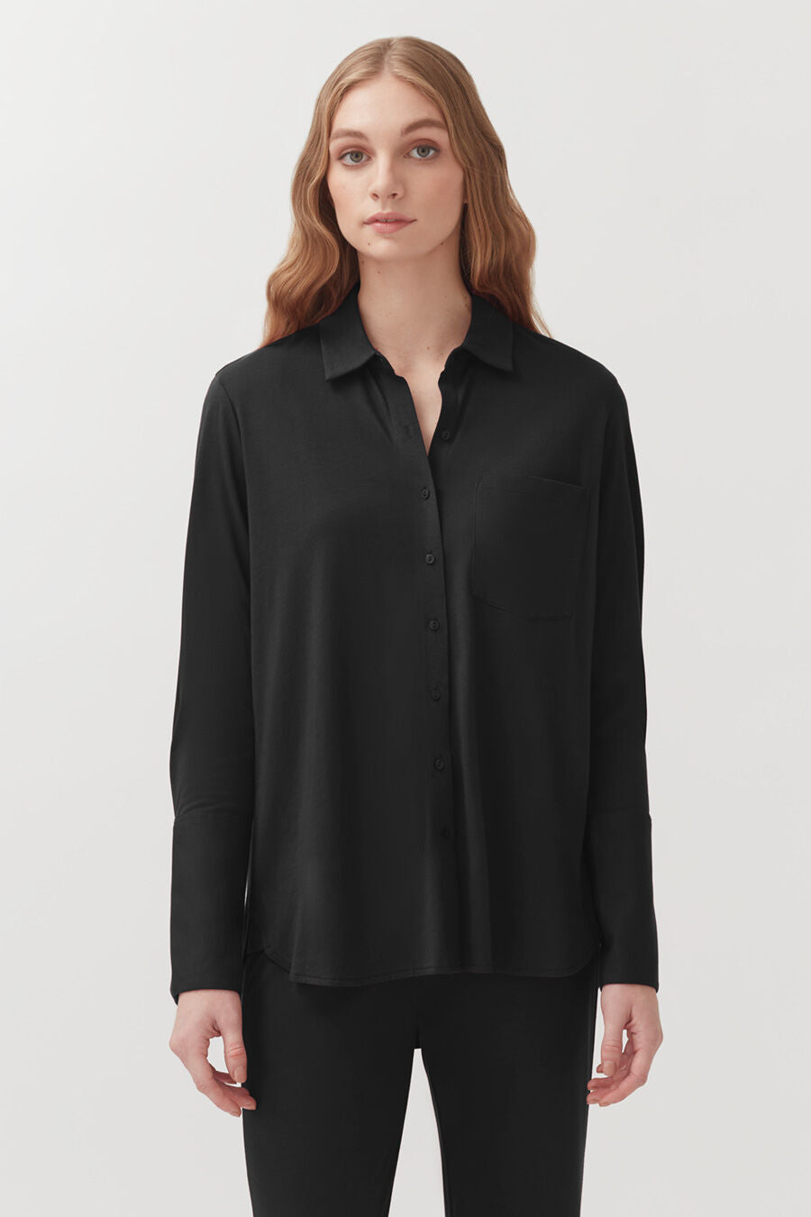 Organic Pima Shirt Woman in a collared, button-up shirt, standing straight.