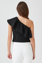 Woman wearing one-shoulder top with ruffle, viewed from back