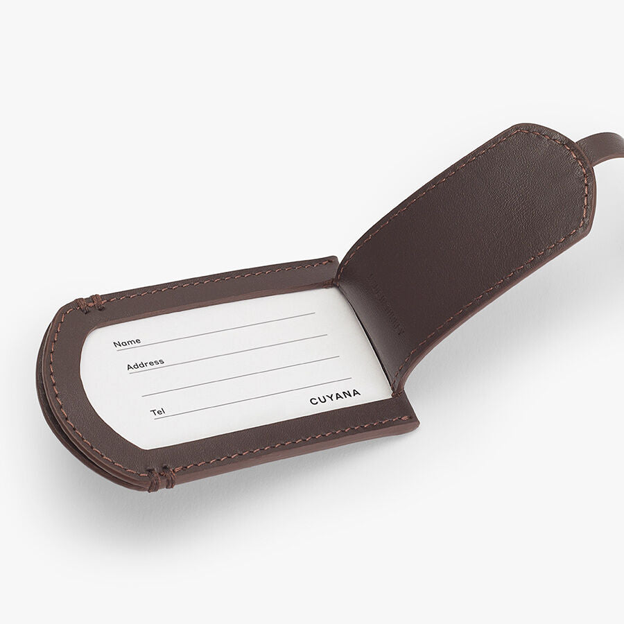 Leather Luggage Tag Open luggage tag with blank information card inside.