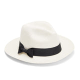 Straw hat with a ribbon bow on a plain background.