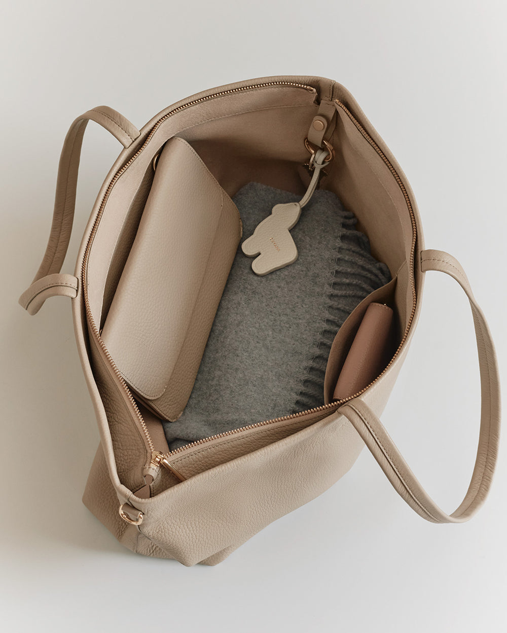 Open bag with a wallet, book, and keychain inside.