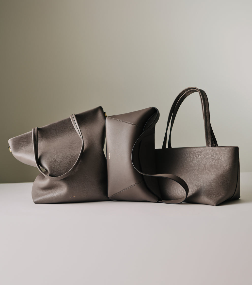 Three tote bags displayed on a flat surface.