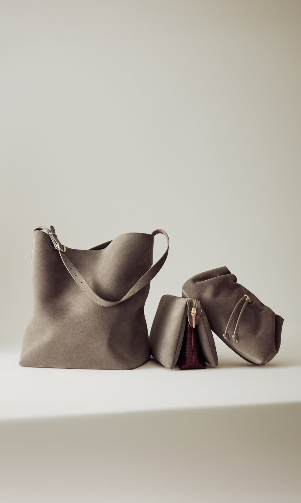 A large tote bag and two smaller pouches on a flat surface.