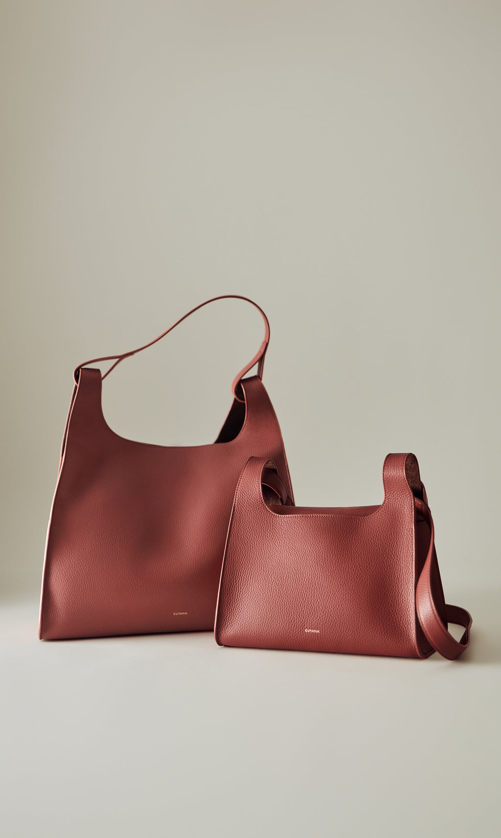 Two tote bags of different sizes with short handles displayed upright.