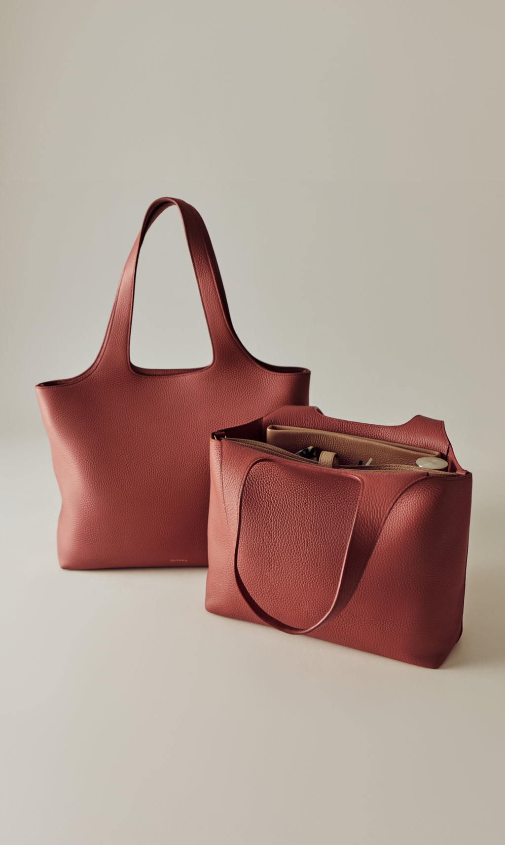 Two tote bags, one upright and one open with items inside.