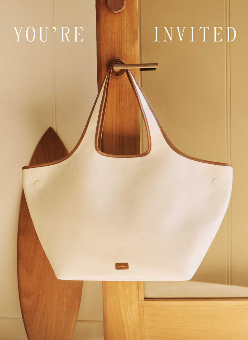 Tote bag hanging on a wooden hook with text above.