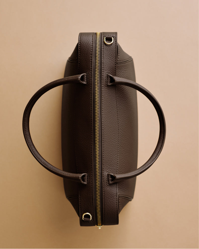 Top view of a bag with two handles and a zipper down the center.
