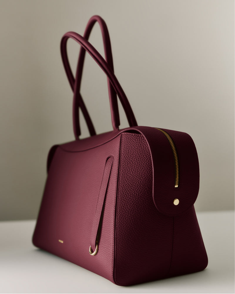 Handbag with double handles on a table
