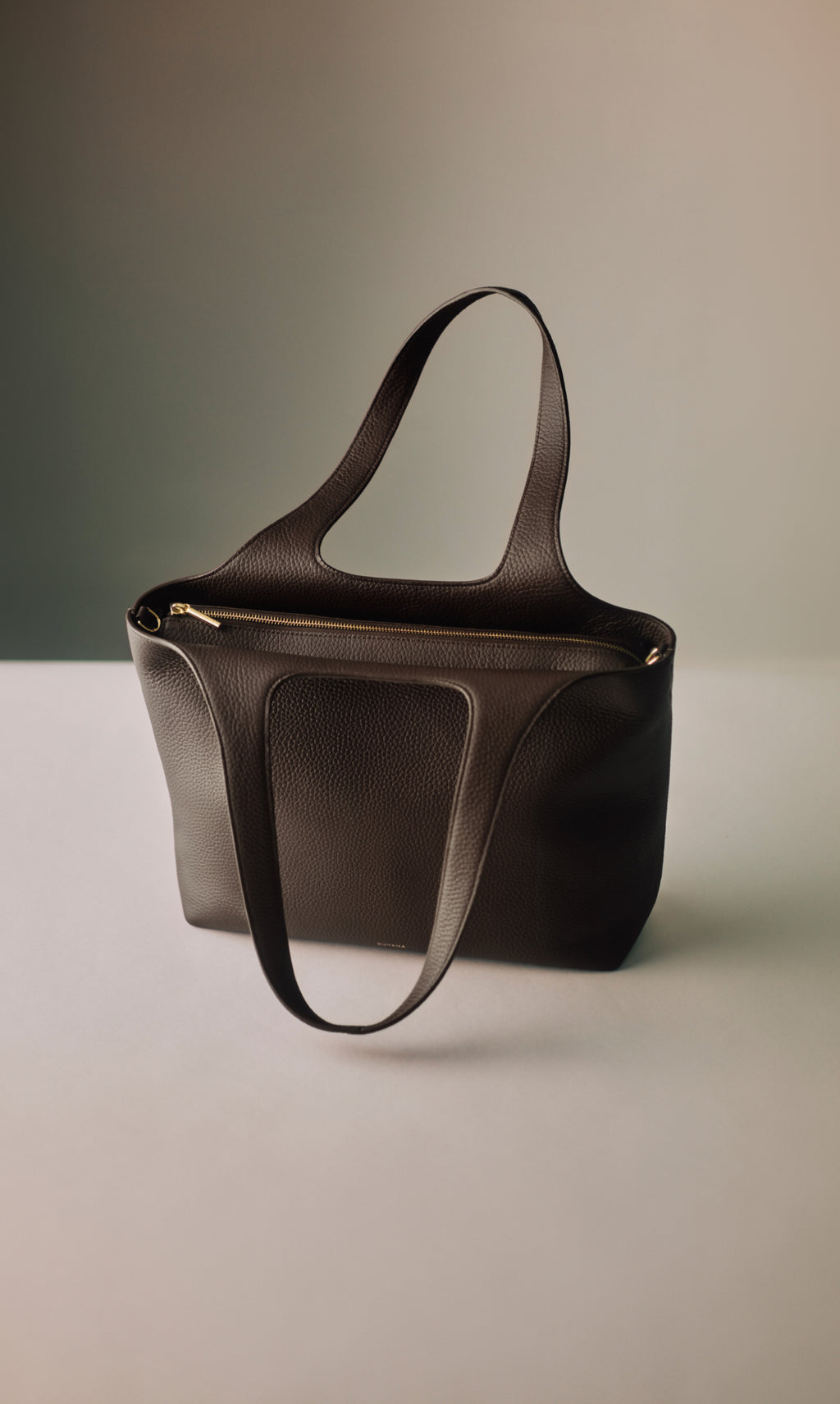 Tote bag with long handles on a flat surface.
