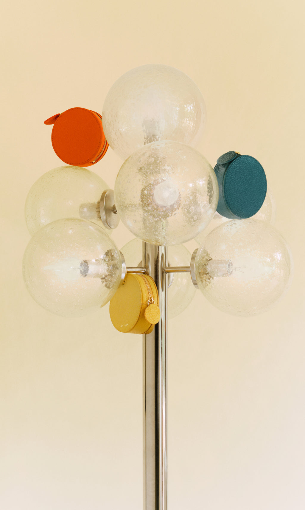 Round bags attached to a metal lamp with glass globes.