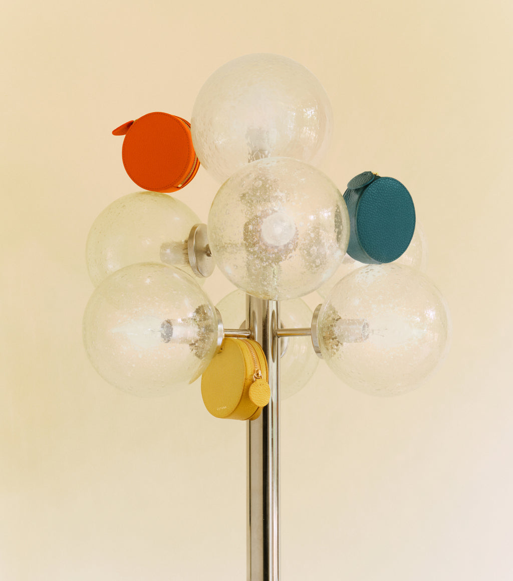 Lamp with spherical bulbs featuring small circular cases attached.