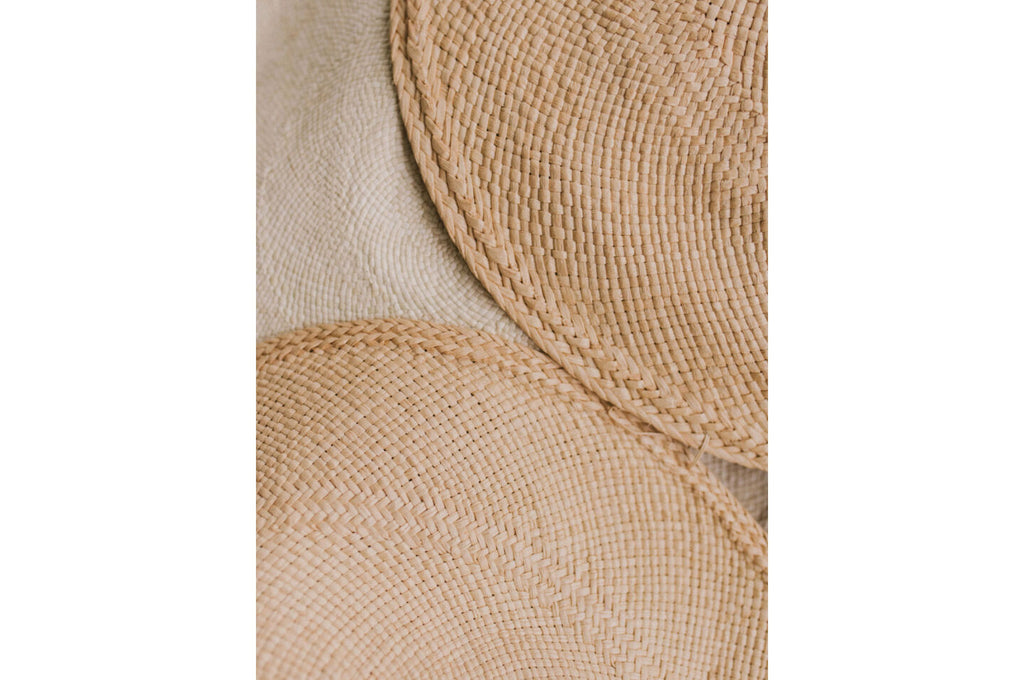Three straw hats overlapping each other.