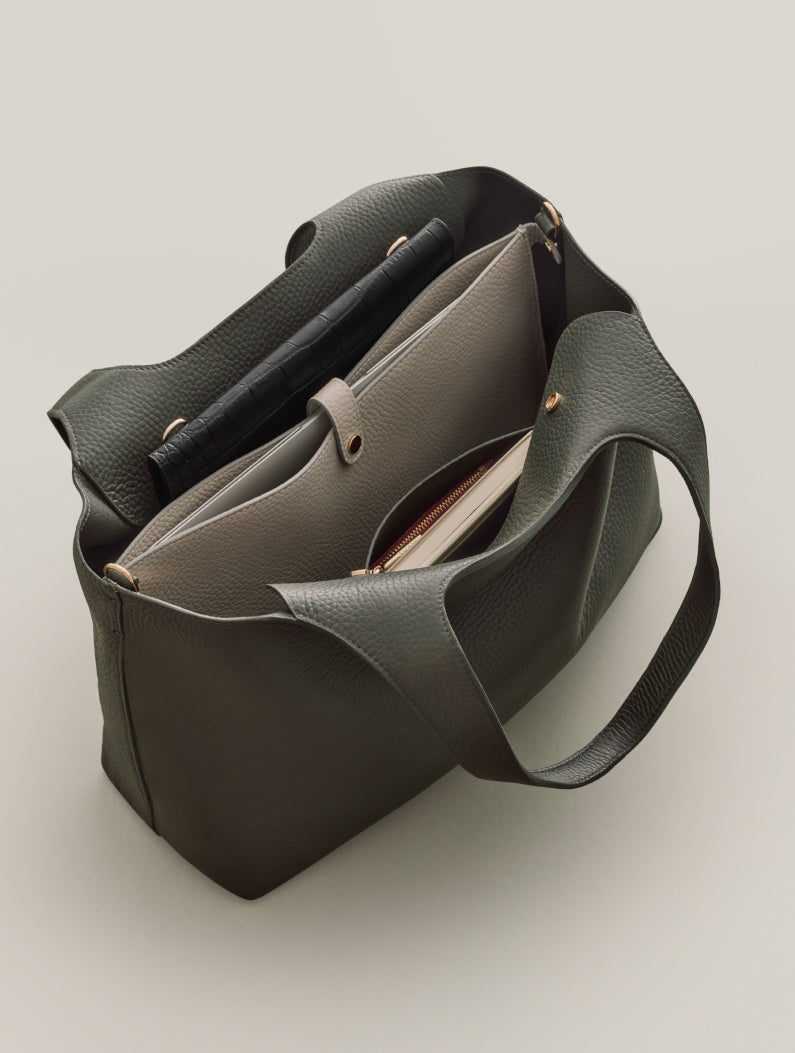 Open handbag with multiple compartments and two handles.