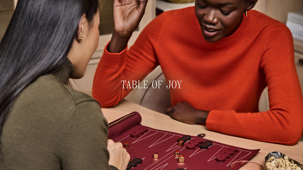 Two people playing a board game at a table.