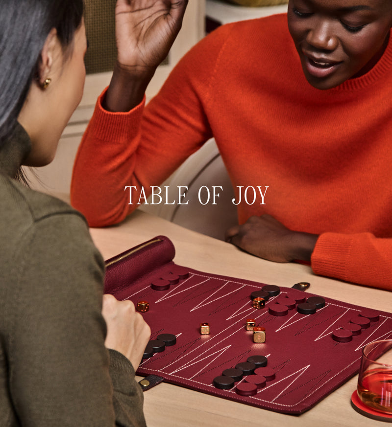 Two people playing a board game at a table.