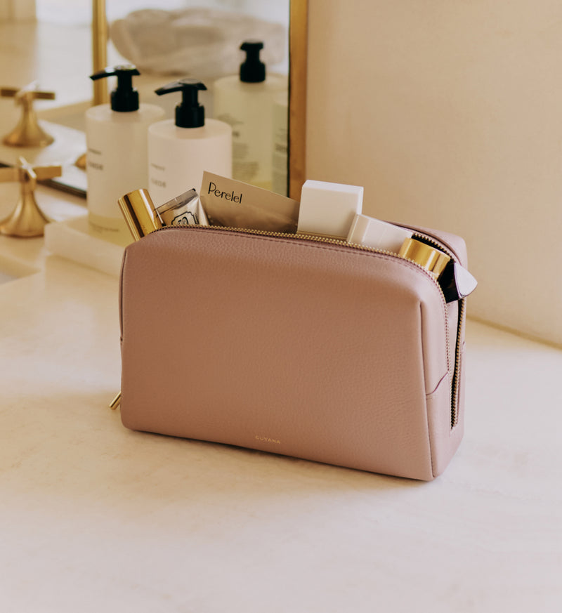Cosmetic bag on counter with toiletries and beauty products inside