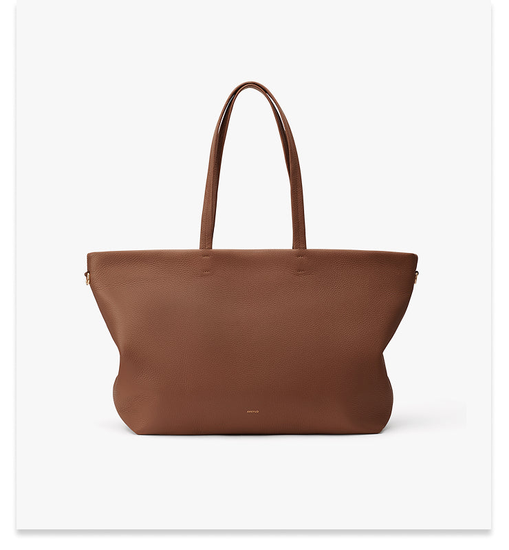 Large tote bag with long handles and a smooth surface.