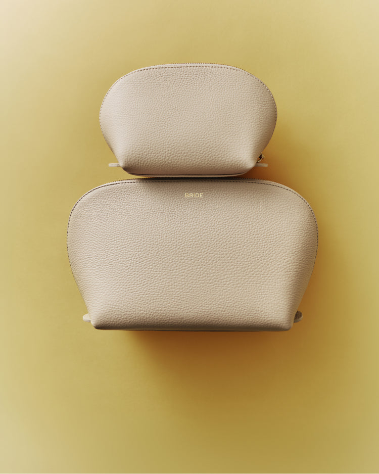Two nested zippered pouches on a plain background.