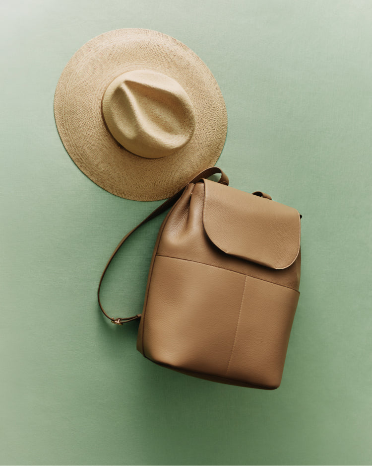 Hat and backpack on a flat surface.