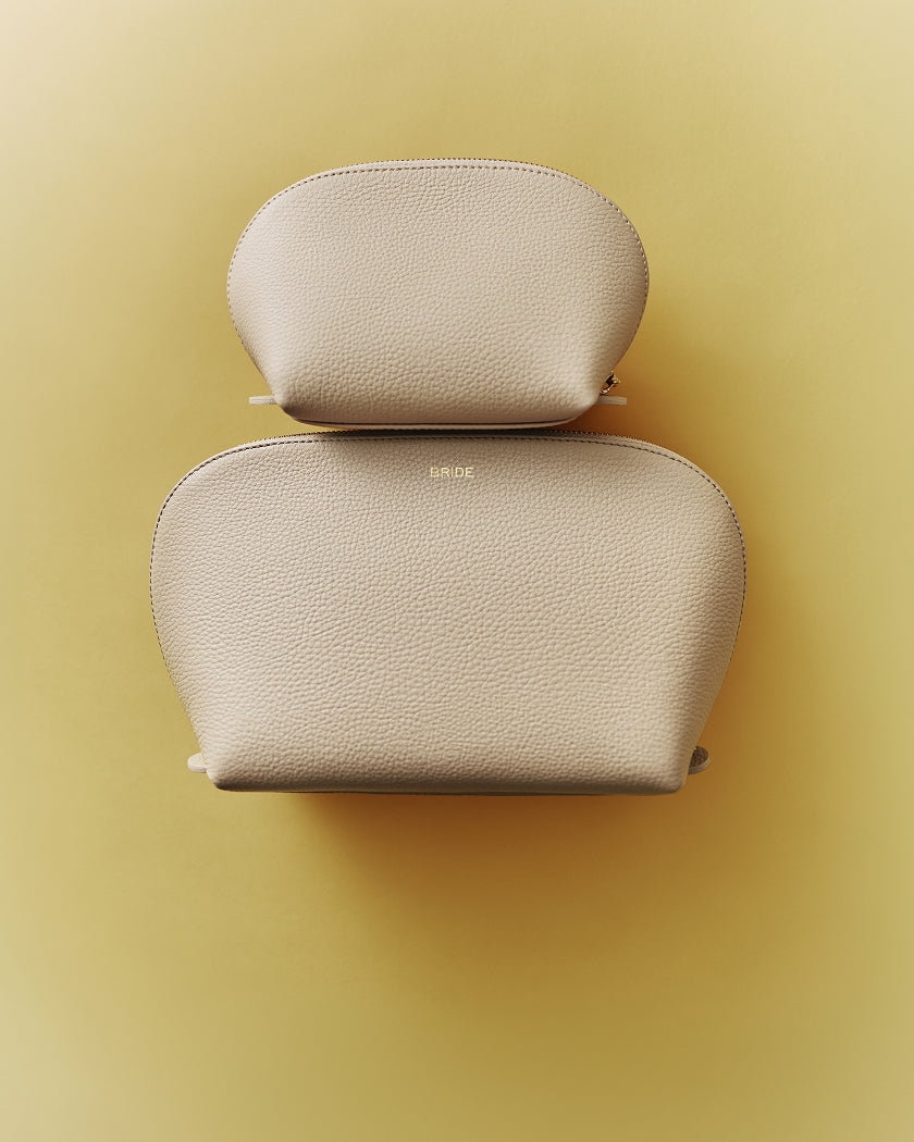 Two textured pouches stacked on a flat surface.