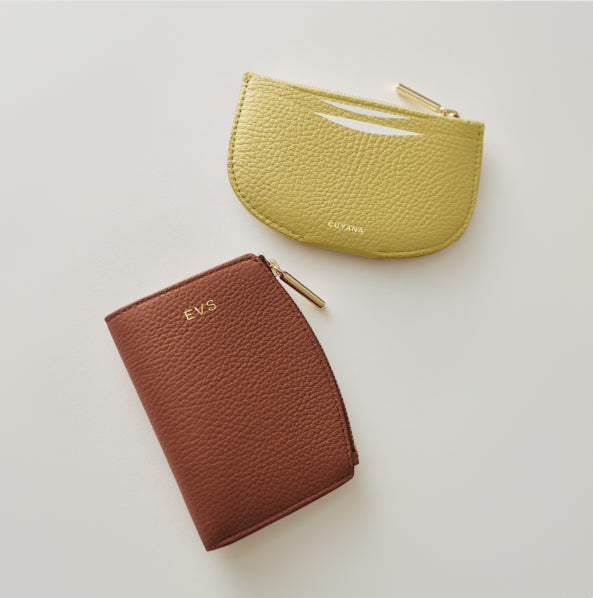 Two textured leather wallets displayed on a flat surface.