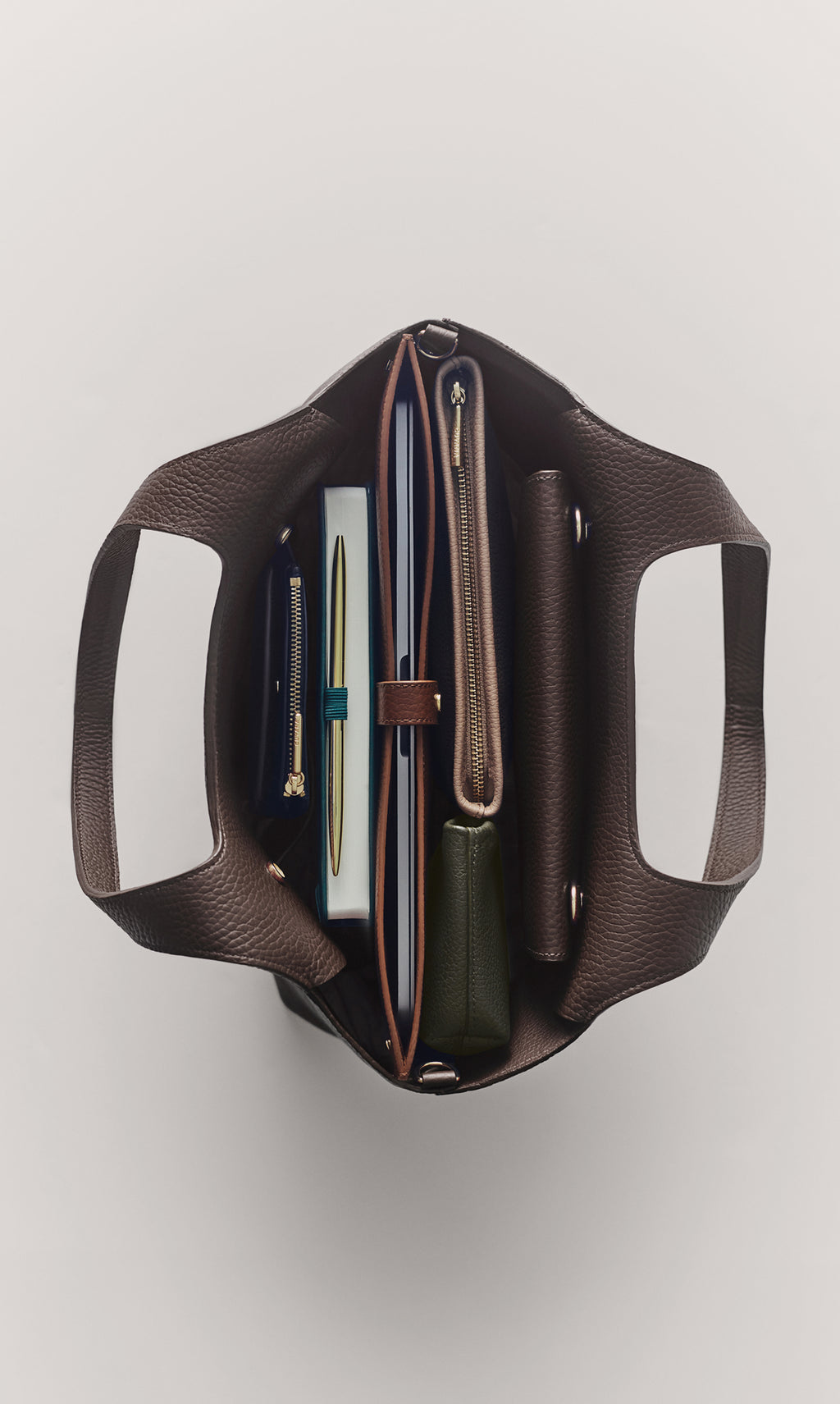 Open tote bag with neatly organized items inside viewed from above.