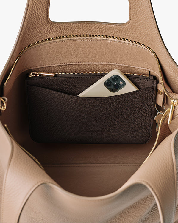 Open handbag with a wallet and a phone inside pocket.